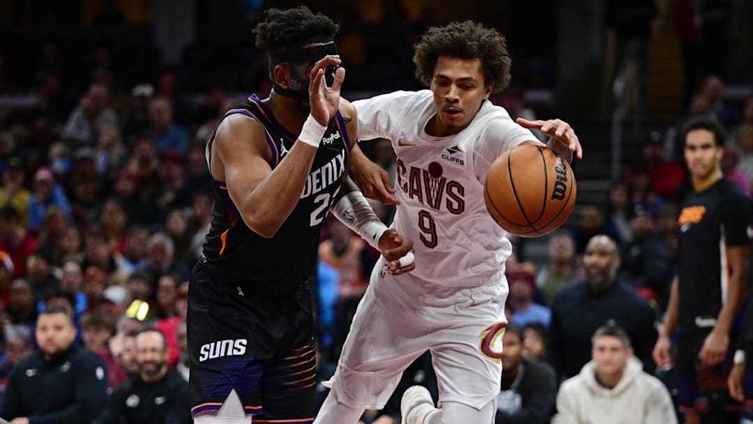 Dec 31, 2025; Cleveland, Ohio, USA; Cleveland Cavaliers guard Craig Porter Jr. (9) attempt to keep a loose ball from going out of bounds while being pressured by Phoenix Suns guard Jordan Goodwin (23) during the second half at Rocket Arena. Mandatory Credit: David Dermer-Imagn Images