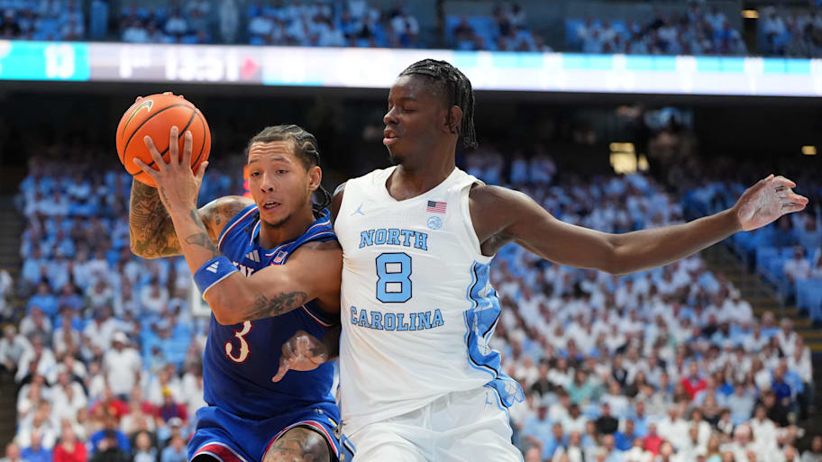 Kansas guard Tre White drives against North Carolina forward Caleb Wilson.