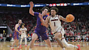 Jan 7, 2025; Louisville, Kentucky, USA; Louisville Cardinals guard J'Vonne Hadley (1) drives to the basket against Clemson Tigers forward Ian Schieffelin (4) during the second half at KFC Yum! Center. Louisville defeated Clemson 74-64. Mandatory Credit: Jamie Rhodes-Imagn Images