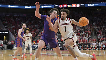 Jan 7, 2025; Louisville, Kentucky, USA; Louisville Cardinals guard J'Vonne Hadley (1) drives to the basket against Clemson Tigers forward Ian Schieffelin (4) during the second half at KFC Yum! Center. Louisville defeated Clemson 74-64. Mandatory Credit: Jamie Rhodes-Imagn Images