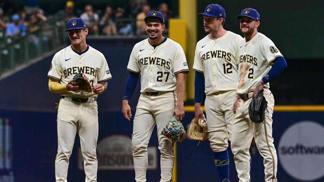 Sep 18, 2024; Milwaukee, Wisconsin, USA;  Milwaukee Brewers third baseman Joseph Ortiz (3), shortstop Willy Adames (27), first baseman Rhys Hoskins (12) and second baseman Brice Turang (2) waits for a pitching change in the sixth inning against the Philadelphia Phillies at American Family Field. Mandatory Credit: Benny Sieu-Imagn Images