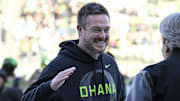 Nov 22, 2025; Eugene, Oregon, USA; Oregon Ducks head coach Dan Lanning smiles before the game against the Southern California Trojans at Autzen Stadium. Mandatory Credit: Troy Wayrynen-Imagn Images