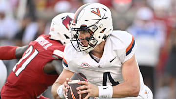 Virginia Cavaliers quarterback Chandler Morris (4) scrambles to get open against Louisville Cardinals defensive back D'Angelo Hutchinson (21) during the second half. Virginia defeated Louisville 30-27. Credit: Jamie Rhodes-Imagn Images