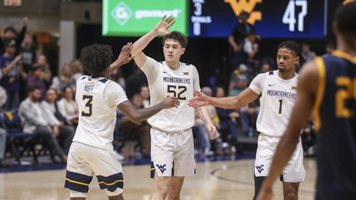 Dec 3, 2025; Morgantown, West Virginia, USA; West Virginia Mountaineers guard Honor Huff (3) celebrates with West Virginia Mountaineers guard Treysen Eaglestaff (52) and West Virginia Mountaineers guard Jasper Floyd (1) during the second half against the Coppin State Eagles at Hope Coliseum. Mandatory Credit: Ben Queen-Imagn Images