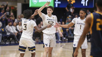 Dec 3, 2025; Morgantown, West Virginia, USA; West Virginia Mountaineers guard Honor Huff (3) celebrates with West Virginia Mountaineers guard Treysen Eaglestaff (52) and West Virginia Mountaineers guard Jasper Floyd (1) during the second half against the Coppin State Eagles at Hope Coliseum. Mandatory Credit: Ben Queen-Imagn Images