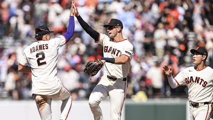 San Francisco, California, USA; San Francisco Giants shortstop Willy Adames (2) and outfielder Jared Oliva (56) high five after defeating the Philadelphia Phillies 5-0 at Oracle Park. Mandatory Credit: Justine Willard-Imagn Images