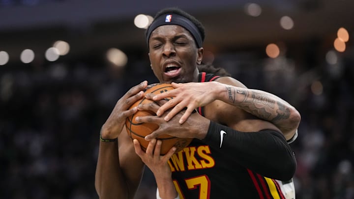Atlanta Hawks center Onyeka Okongwu and Milwaukee Bucks guard Ryan Rollins battle for control of the ball