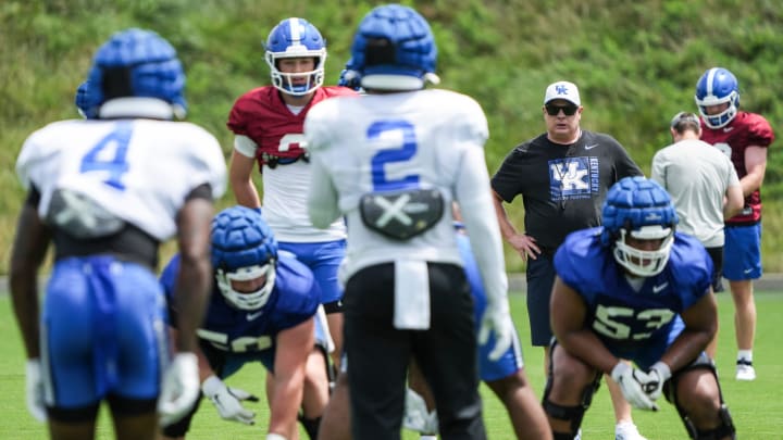 Kentucky head coach Mark Stoops, in black t-shirt, watches a play during practice Friday. August 2, 2024 in Lexington. Stoops has a 63-65 record with the Wildcats so far; he's the all-time winningest head coach in the history of the Kentucky football program. He is also the longest tenured SEC football coach.