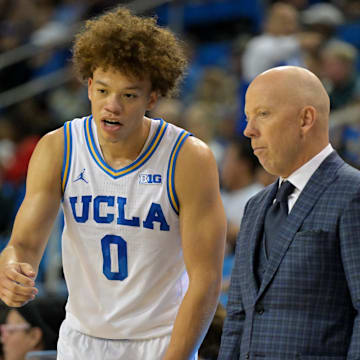 Nov 10, 2025; Los Angeles, California, USA;  UCLA Bruins guard Trent Perry (0) talks with head coach Mick Cronin during the first half against the West Georgia Wolves at Pauley Pavilion presented by Wescom Financial. Mandatory Credit: Jayne Kamin-Oncea-Imagn Images