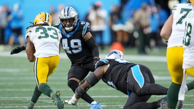  Aaron Jones (33) is tackled by Carolina Panthers linebacker Frankie Luvu (49) and defensive end Nick Thurman