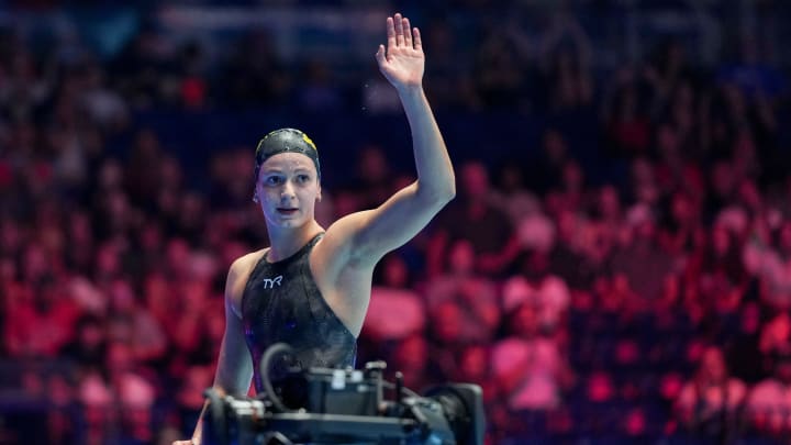 Katie Grimes waves to the crowd after winning the 400-meter individual medley final Monday during the third day of competition for the U.S. Olympic Team Swimming Trials at Lucas Oil Stadium in Indianapolis.