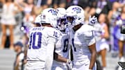 Sep 20, 2025; Fort Worth, Texas, USA; TCU Horned Frogs wide receiver Eric McAlister (1) celebrates with quarterback Josh Hoover (10) and running back Trent Battle (6) after McAlister scores a touchdown against the SMU Mustangs during the second half at Amon G. Carter Stadium. Mandatory Credit: Jerome Miron-Imagn Images