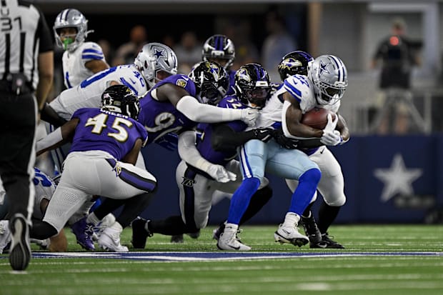 Dallas Cowboys RB Miles Sanders is tackled by the Baltimore Ravens defense.