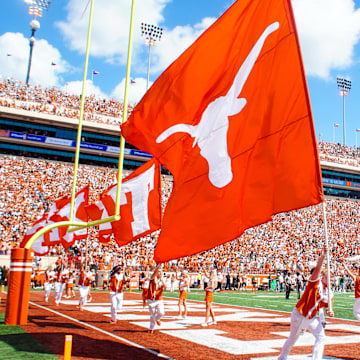 Aug 31, 2024; Austin, Texas, USA; Texas Longhorns cheerleaders waves the flag after a topdown during the first half of s gams at Darrell K Royal-Texas Memorial Stadium. Mandatory Credit: Aaron Meullion-Imagn Images