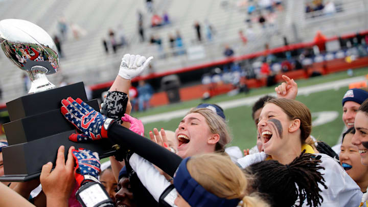 Members of the Eagles flag football team celebrate after receiving a trophy for a 12-7 win over the Steelers team during the Big 33's second annual girls flag football tournament Sunday at Champman Field.