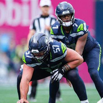 Sep 22, 2024; Seattle, Washington, USA; Seattle Seahawks center Connor Williams (57) prepares to snap the ball during the fourth quarter against the Miami Dolphins at Lumen Field. Mandatory Credit: Kevin Ng-Imagn Images