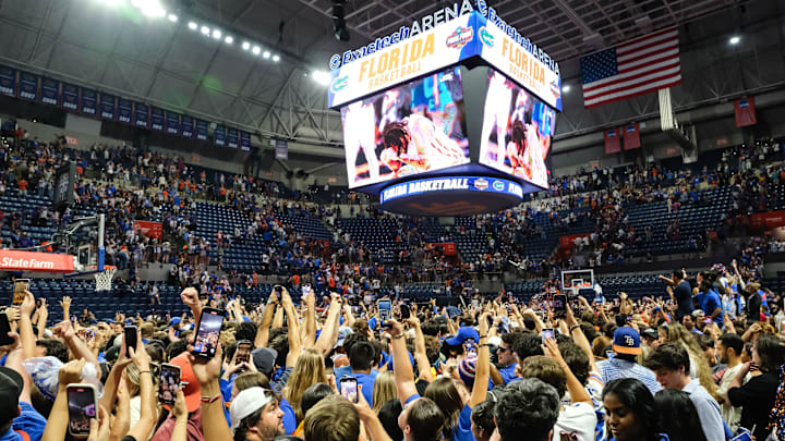 Gator fans storm the court after the Florida Gators win the NCAA national championship men's basketball game between the Florida Gators and the Houston Cougars in Gainesville, FL on Monday, April 7, 2025.