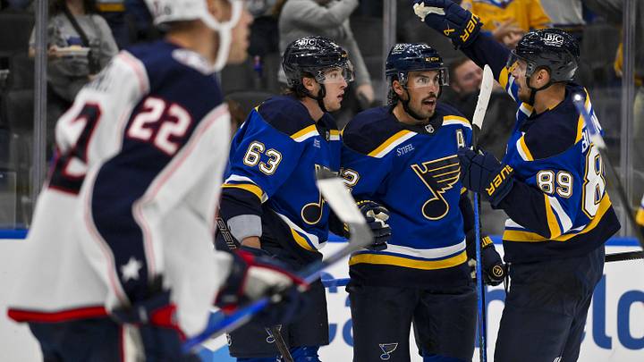 Oct 1, 2024; St. Louis, Missouri, USA;  St. Louis Blues defenseman Justin Faulk (72) is congratulated by left wing Jake Neighbours (63) and left wing Pavel Buchnevich (89) after scoring against the Columbus Blue Jackets during the second period at Enterprise Center. Mandatory Credit: Jeff Curry-Imagn Images
