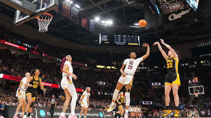 Iowa Hawkeyes guard Caitlin Clark (22) shoots the ball as South Carolina Gamecocks guard Bree Hall (23) defends during the NCAA Tournament championship basketball game at Rocket Mortgage Fieldhouse, Sunday, April 7, 2024 in Cleveland.