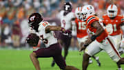 Sep 27, 2024; Miami Gardens, Florida, USA; Virginia Tech Hokies wide receiver Jaylin Lane (83) runs with the football past Miami Hurricanes linebacker Malik Bryant (24) during the fourth quarter at Hard Rock Stadium. Mandatory Credit: Sam Navarro-Imagn Images