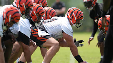 Jun 10, 2025; Cincinnati, OH, USA; Cincinnati Bengals center Ted Karras (64) (center) lines up with the offensive line at the line of scrimmage against the defensive line during practice at Paycor Stadium. Mandatory Credit: Kareem Elgazzar-Imagn Images