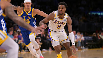 Oct 12, 2025; Los Angeles, California, USA;  Los Angeles Lakers guard Bronny James (9) drives past Golden State Warriors forward Gui Santos (15) in the first half at Crypto.com Arena. Mandatory Credit: Jayne Kamin-Oncea-Imagn Images