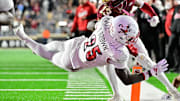 Oct 25, 2024; Chestnut Hill, Massachusetts, USA; Louisville Cardinals running back Isaac Brown (25) dives for a touchdown against the Boston College Eagles during the first half at Alumni Stadium. Mandatory Credit: Eric Canha-Imagn Images