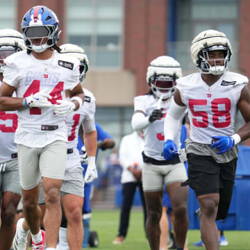 Jul 25, 2024; East Rutherford, NY, USA; New York Giants linebacker Brian Burns (0), cornerback Nick McCloud (44) and inside linebacker Bobby Okereke (58) take the field during training camp at Quest Diagnostics Training Center.  