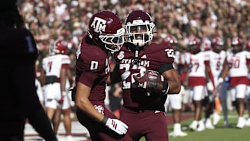 Nov 15, 2025; College Station, Texas, USA; Texas A&M Aggies running back Ej Smith (22) celebrates with wide receiver Izaiah Williams (0) after scoring a touchdown during the fourth quarter against the South Carolina Gamecocks at Kyle Field. Mandatory Credit: Troy Taormina-Imagn Images