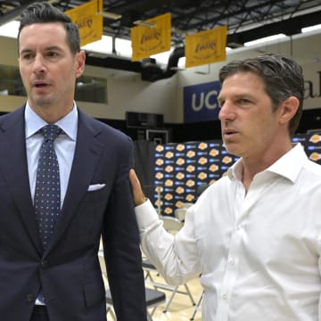 Jun 24, 2024; El Segundo, CA, USA; Los Angeles Lakers head coach JJ Redick talks with his agent Steven Heunann following his introductory news conference at the UCLA Health Training Center. Mandatory Credit: Jayne Kamin-Oncea-USA TODAY Sports