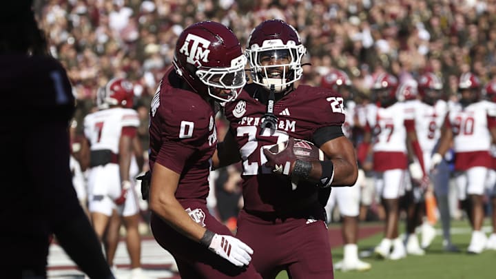 Nov 15, 2025; College Station, Texas, USA; Texas A&M Aggies running back Ej Smith (22) celebrates with wide receiver Izaiah Williams (0) after scoring a touchdown during the fourth quarter against the South Carolina Gamecocks at Kyle Field. Mandatory Credit: Troy Taormina-Imagn Images