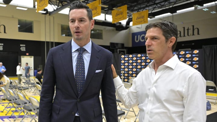 Jun 24, 2024; El Segundo, CA, USA; Los Angeles Lakers head coach JJ Redick talks with his agent Steven Heunann following his introductory news conference at the UCLA Health Training Center. Mandatory Credit: Jayne Kamin-Oncea-USA TODAY Sports