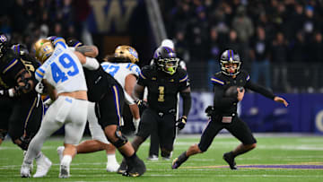 Nov 15, 2024; Seattle, Washington, USA; Washington Huskies quarterback Demond Williams Jr. (2) carries the ball against the UCLA Bruins during the second half at Alaska Airlines Field at Husky Stadium. Mandatory Credit: Steven Bisig-Imagn Images