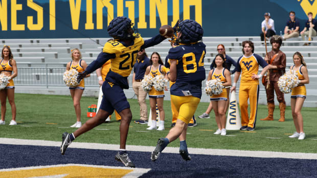 West Virginia redshirt sophomore receiver Hudson Clement hauls in a touchdown pass over redshirt junior defensive back Ayden Garnes in a 1v1 drill during the 2024 Gold-Blue Spring Game.
