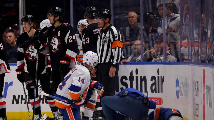 Nov 1, 2024; Buffalo, New York, USA;  Trainers attend to New York Islanders defenseman Mike Reilly (2) after getting hurt during the second period against the Buffalo Sabres at KeyBank Center. Mandatory Credit: Timothy T. Ludwig-Imagn Images
