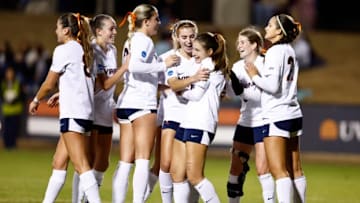 The Cavaliers Celebrate with Kira Waller after his assit to Sophia Bradley.