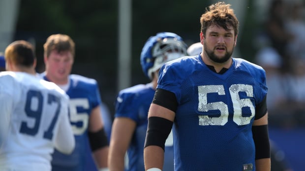 Colts offensive guard Quenton Nelson (blue jersey with white numbers) gets ready for a training camp practice. 