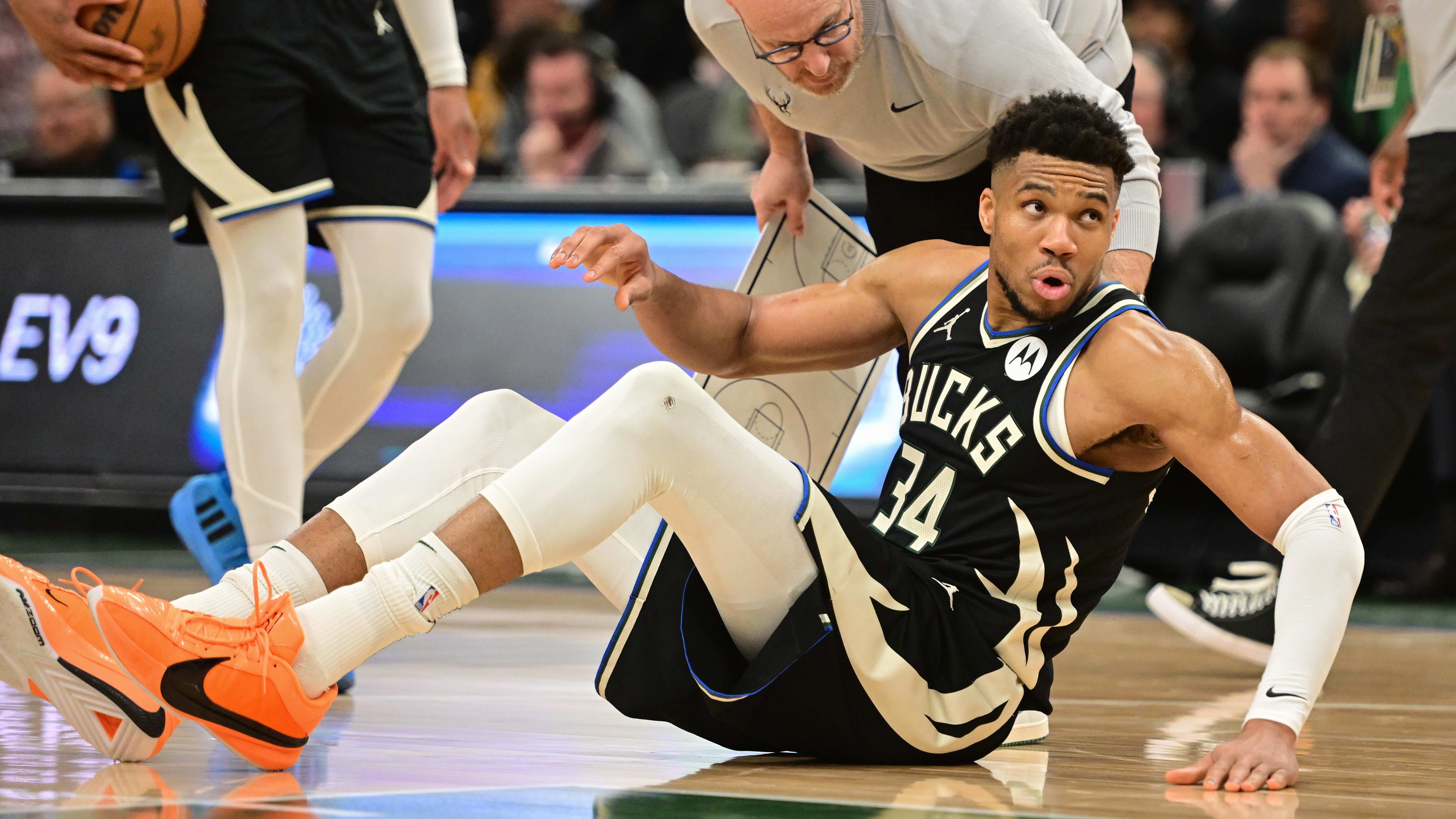 Giannis Antetokounmpo is helped off the court