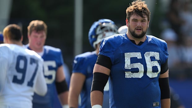 Colts guard Quenton Nelson (blue jersey; white number) takes a breather during a training camp practice. 