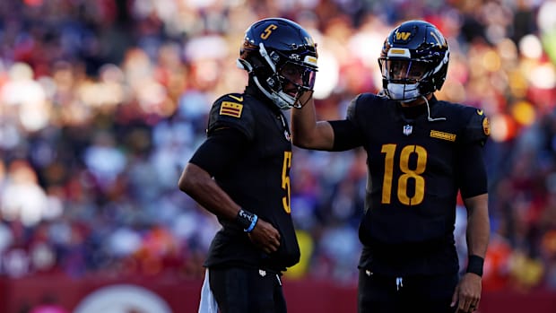 Oct 27, 2024; Landover, Maryland, USA; Washington Commanders quarterback Jayden Daniels (5) and quarterback Marcus Mariota (1