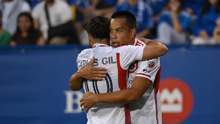 Aug 24, 2024; Montreal, Quebec, CAN; New England Revolution midfielder Carles Gil (10) and New England Revolution forward Bobby Wood (17) celebrate a first half goal at Stade Saputo. Mandatory Credit: David Kirouac-USA TODAY Sports