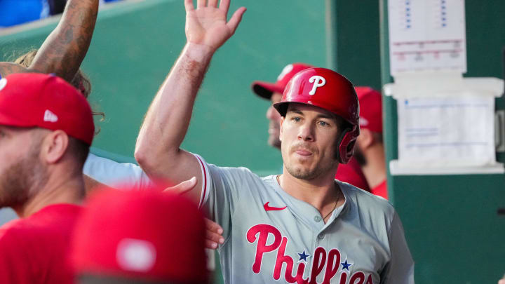 Aug 23, 2024; Kansas City, Missouri, USA; Philadelphia Phillies catcher J.T. Realmuto (10) celebrates in the dugout after scoring against the Kansas City Royals in the third inning at Kauffman Stadium.