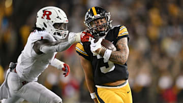 Nov 11, 2023; Iowa City, Iowa, USA; Iowa Hawkeyes wide receiver Kaleb Brown (3) gets yards after the catch as Rutgers Scarlet Knights lineback Mohamed Toure (1) reaches for the tackle during the fourth quarter at Kinnick Stadium. Mandatory Credit: Jeffrey Becker-Imagn Images