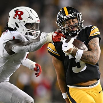 Nov 11, 2023; Iowa City, Iowa, USA; Iowa Hawkeyes wide receiver Kaleb Brown (3) gets yards after the catch as Rutgers Scarlet Knights lineback Mohamed Toure (1) reaches for the tackle during the fourth quarter at Kinnick Stadium. Mandatory Credit: Jeffrey Becker-Imagn Images