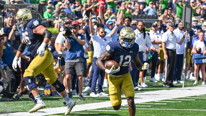 Sep 2, 2023; South Bend, Indiana, USA; Notre Dame Fighting Irish running back Jeremiah Love (12) runs for a touchdown in the first quarter against the Tennessee State Tigers at Notre Dame Stadium. Mandatory Credit: Matt Cashore-Imagn Images