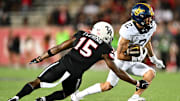 Oct 12, 2023; Houston, Texas, USA; West Virginia Mountaineers wide receiver Rodney Gallagher (2) runs the ball during the second half as Houston Cougars defensive back Malik Fleming (15) defends at TDECU Stadium. Mandatory Credit: Maria Lysaker-Imagn Images