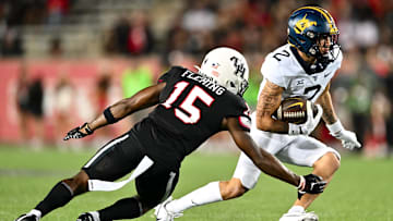 Oct 12, 2023; Houston, Texas, USA; West Virginia Mountaineers wide receiver Rodney Gallagher (2) runs the ball during the second half as Houston Cougars defensive back Malik Fleming (15) defends at TDECU Stadium. Mandatory Credit: Maria Lysaker-Imagn Images