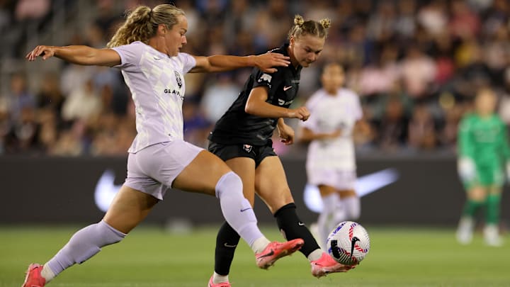 Racing Louisville FC midfielder Jaelin Howell (6) and Angel City FC midfielder Kennedy Fuller (17) battle for the ball in the second half at BMO Stadium 