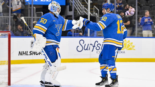 Hockey goalie and teammate celebrate win