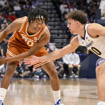 Mar 12, 2025; Nashville, TN, USA;  Vanderbilt Commodores guard Chris Manon (30) guards Texas Longhorns guard Tre Johnson (20) during the second half at Bridgestone Arena. Mandatory Credit: Steve Roberts-Imagn Images